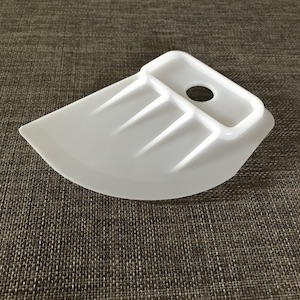 white plastic large spatula for tucking a fabric