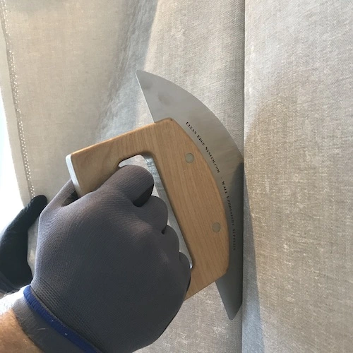 installer tucking the fabric in track system